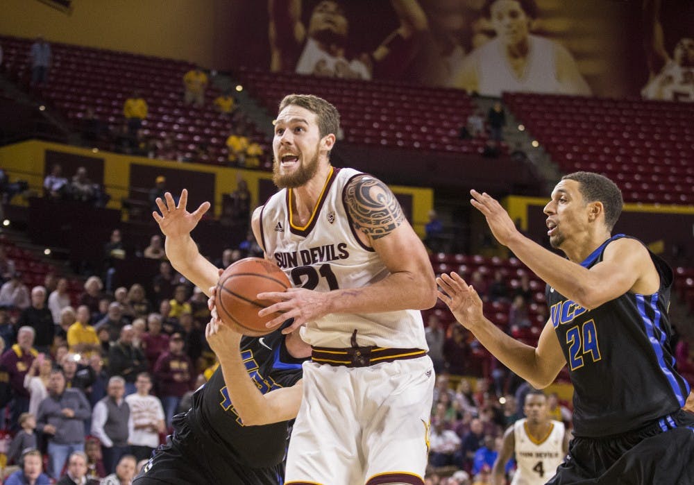 Arizona State Sun Devils forward Eric Jacobsen, center, rebounds the ball before sinking the game-winning, put-back basket during a game against UC Santa Barbara at Wells Fargo Arena in Tempe, Ariz., on Sunday, Nov. 29, 2015. The ASU Sun Devils took down the UC Santa Barbara Gauchos, 70-68.