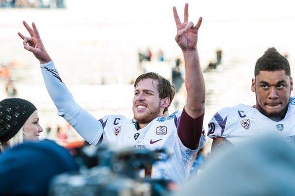 Redshirt senior quarterback Taylor Kelly (left) celebrates after the Sun Bowl against Duke, Saturday, Dec. 27, 2014 at Sun Bowl Stadium in El Paso. The Sun Devils defeated the Blue Devils 36-31. (Ben Moffat/The State Press)