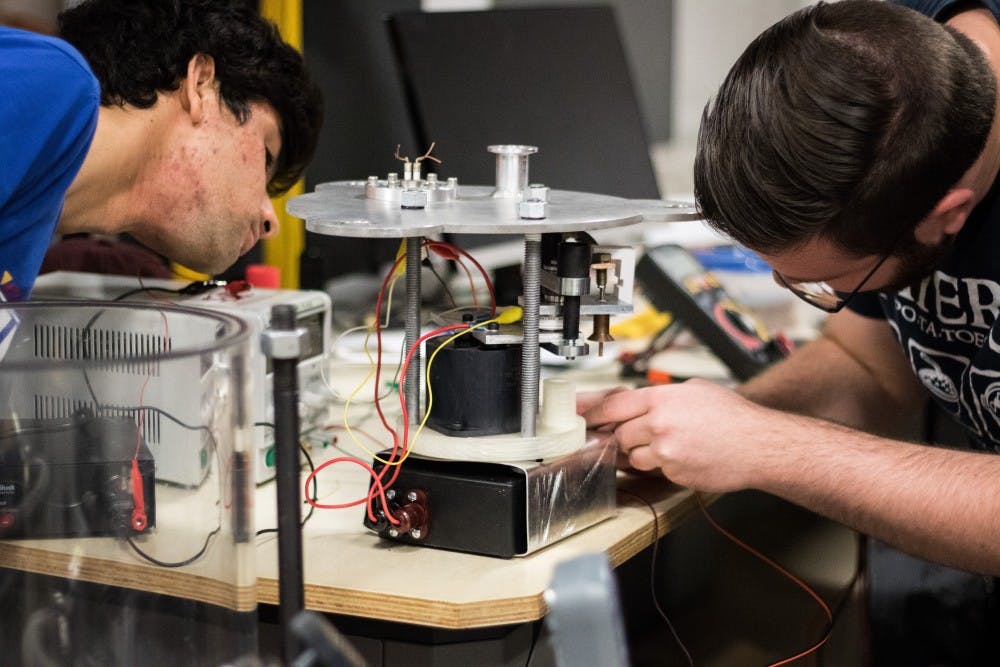 Aditya Van Der Khuller, left,&nbsp;and Joe Mayer&nbsp;adjust the spark mechanism on the pulse plasma thruster on Saturday, Feb. 18, 2017.
