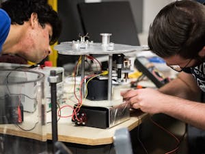 Aditya Van Der Khuller, left,&nbsp;and Joe Mayer&nbsp;adjust the spark mechanism on the pulse plasma thruster on Saturday, Feb. 18, 2017.