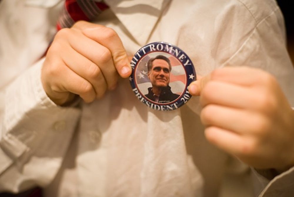 Eight-year-old Draak Clausing shows off his Romney pin.