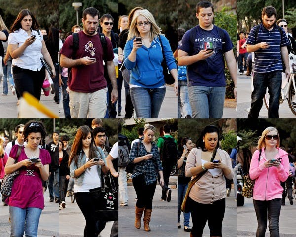 MASS TEXT: Because many professors don't allow the use of cell phones during class, students take the opportunity between classes to catch up on what they missed. Talented texters beware: failing to notice cyclists, vehicles and other traffic can cause accidents just as severe as might be seen on the road. (Photo by Sierra Smith)