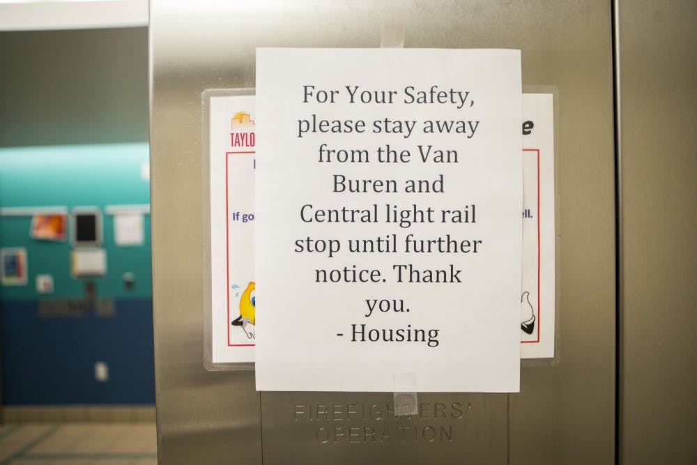 A sign posted in a Taylor Place elevator advises students to avoid the light rail station on Central Avenue and Van Buren Street in Downtown Phoenix on Tuesday, Dec. 8, 2015. ASU sent out a text and email alert to students about a "suspicious package" on Tuesday evening. 