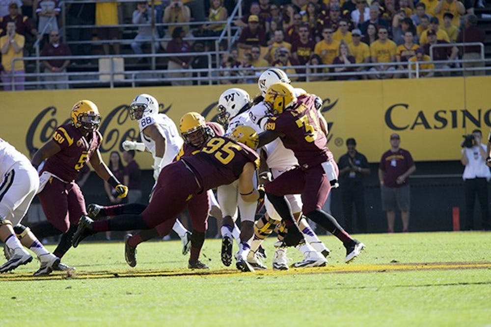 Redshirt senior defensive end Gannon Conway pushes against the offensive line at a home game in Tempe. Conway has two career sacks according to thSunDevils.com and hails from Higley, Ariz. (Photo by Dominic Valente)