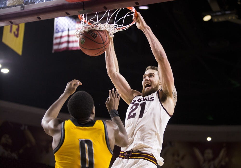 Senior center Eric Jacobsen dunks over Kennesaw State's Kendrick Ray during the fourth quarter on Wednesday, Nov. 18, 2015, at Wells Fargo Arena in Tempe. The Sun Devils took down the Owls 91-53.