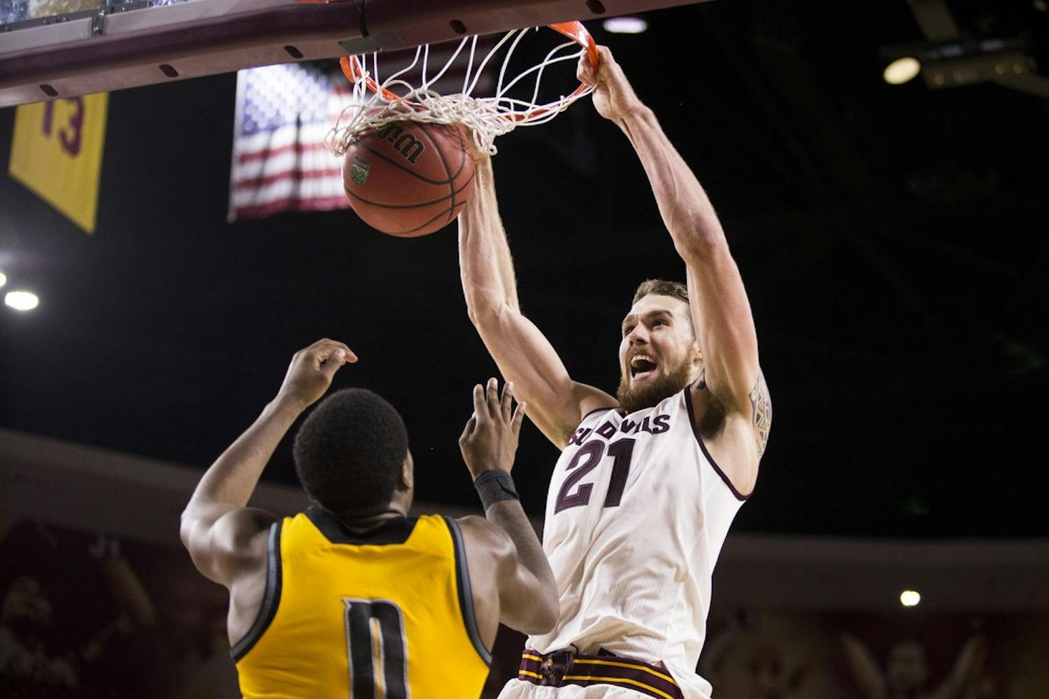 Senior center Eric Jacobsen dunks over Kennesaw State's Kendrick Ray during the fourth quarter on Wednesday, Nov. 18, 2015, at Wells Fargo Arena in Tempe. The Sun Devils took down the Owls 91-53.