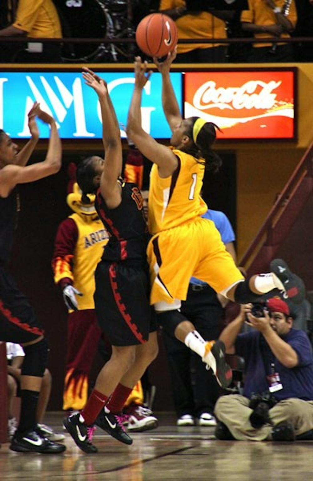Trojan War: Against a wall of USC defenders, ASU redshirt senior guard Dymond Simon pulls up for a layup during the Sun Devils’ 69-55 victory over the Women of Troy on Thursday night in Tempe. ASU has now won three straight games. (Photo by Rosie Gochnour)