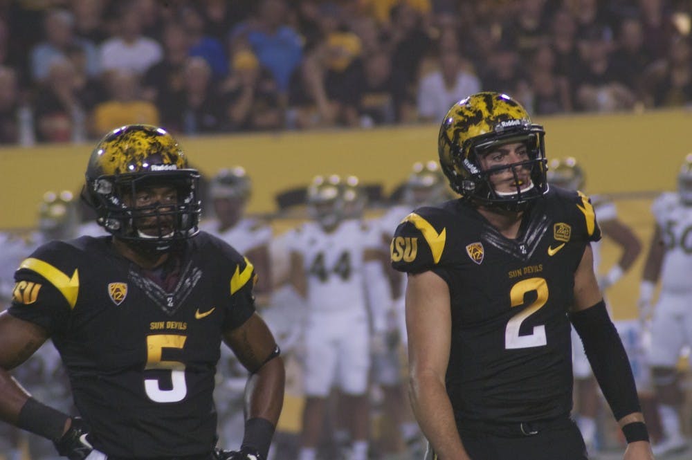 Running back Deantre Lewis, left, and quarterback Mike Bercovici react during ASU's 62-27 loss to UCLA on Sept. 26. (Photo by Fabian Ardaya)