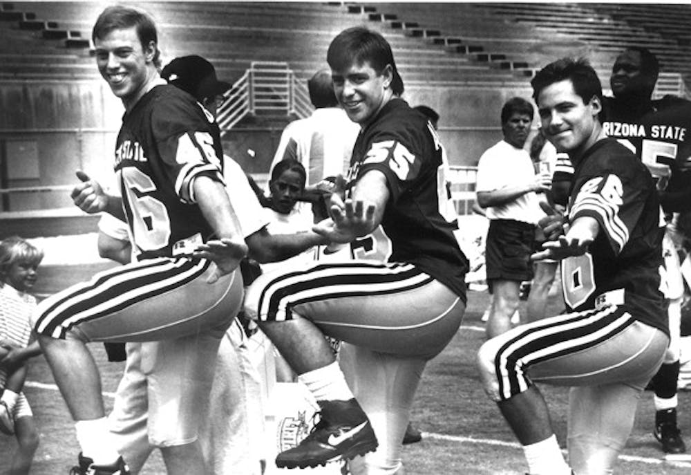 STRIKING A POSE: Seniors Bob Brasher, Chad Ackerley, and Adam Brass have a laugh during football picture day at Sun Devil Stadium on Aug. 29, 1992. (Photo by Darryl Webb)