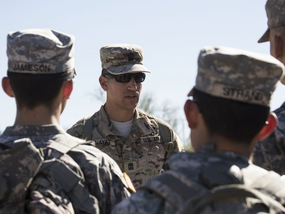 Arizona State University ROTC members listen intently before performing their next drill at Papago Military Reservation in Phoenix, Ariz. on Saturday, Oct. 24, 2015. 