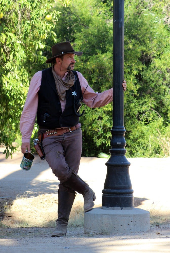 Tom B. Stone, a theatrical character and member of a variety act, sips on some sarsaparilla. 