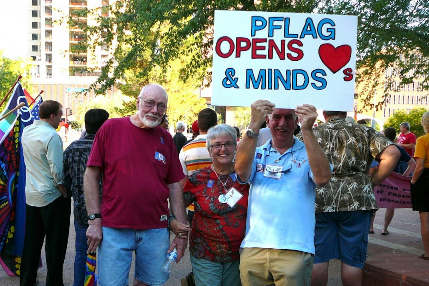 PFLAG president Al Ellie, left, his wife and PFLAG board member Donna Ellis, center, and PFLAG supporter Dave Pape, right, at a rally in downtown Phoenix.