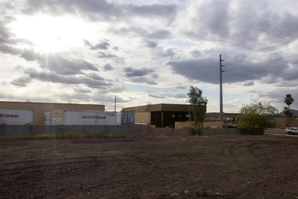 Arizona Forward Association is taking vacant lots such as this one on the Southwest side of the Tempe Canal on Apache Boulevard and renovating them. The Association is planning to renovate several lots around the Tempe campus. (Photo by Dominic Valente)