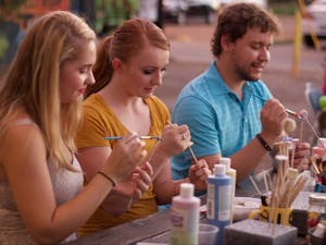 Emma Lunsford (left), Ashley Gilliam and Aaron Hintz volunteer to paint the beads that will eventually become bells during a grand opening celebration of the Phoenix location of the Ben's Bells Project on Friday, Sept. 18, 2015.