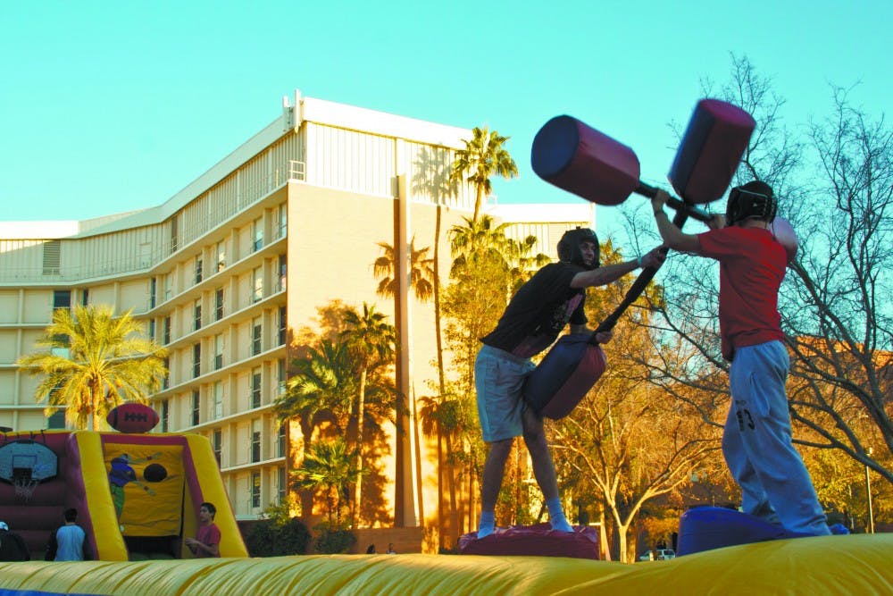 TEMPE GLADIATORS: Freshmen Warren Chabrier and Mitchell Oliver battle it out during Wednesday's Welcome Back BBQ at Palo Verde Beach, hosted by ASU’s Residential Hall Association. (Photo by Lisa Bartoli)