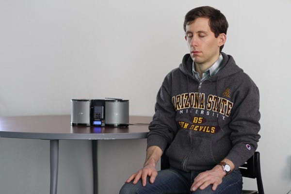 Second-year master's student Sam Chates quietly meditates on Nov. 28 in the University Center building on the Downtown campus. Chates started ASU Mindfulness Community to focus on regulating emotions and managing stress. (Photo by Lisa Bartoli)