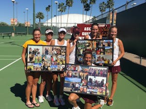 The ASU tennis team poses with presents for the senior class after Senior Day on Saturday, April 2, 2016, at Whiteman Tennis Center in Tempe, Arizona.&nbsp;The Sun Devils defeated WSU 6-1.