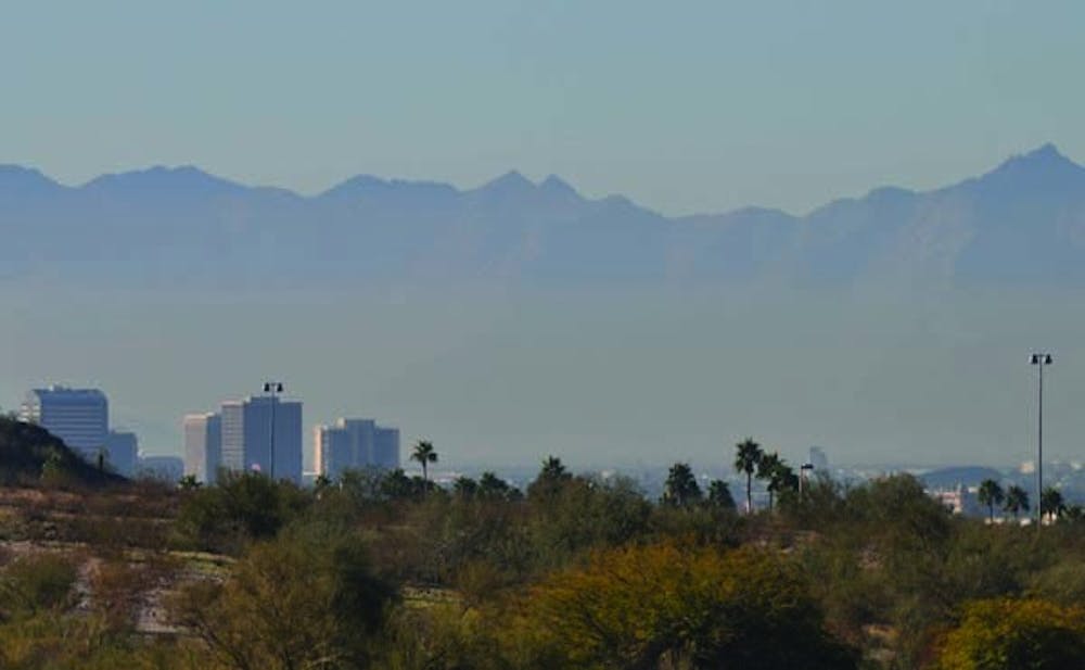 THROUGH THE HAZE: Thick smog and dust, a common sight in Phoenix, obscures the view of the cities mountainous surroundings. (Photo by Christopher Leone) 