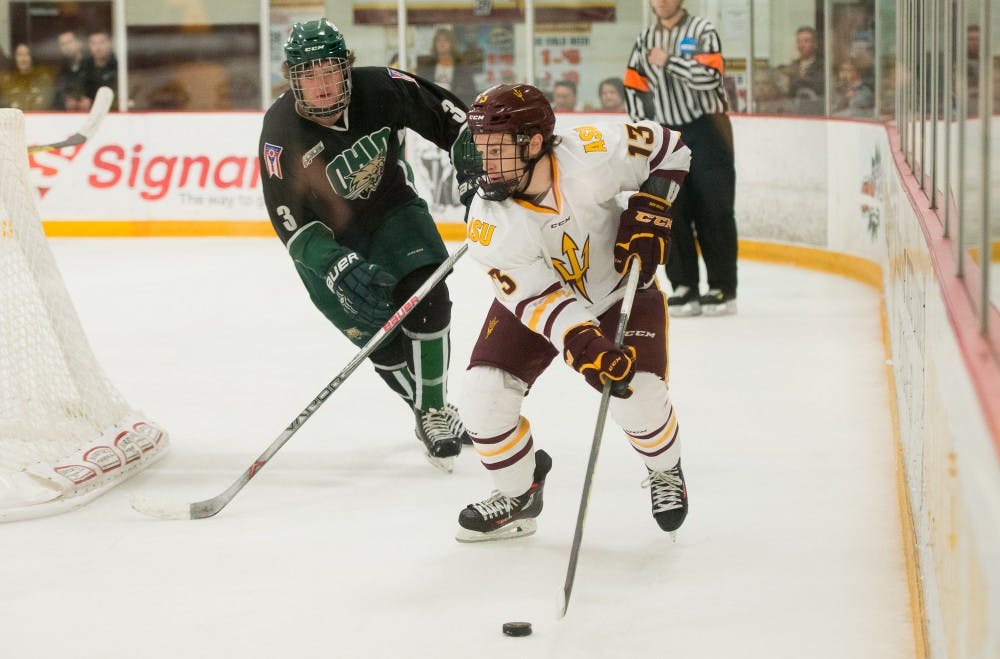 Junior forward Sean Murphy fights for control of the puck against Ohio on Saturday, Jan. 23, 2016, at Oceanside Ice Arena in Tempe. The Sun Devils defeated the Bobcats 6-1.