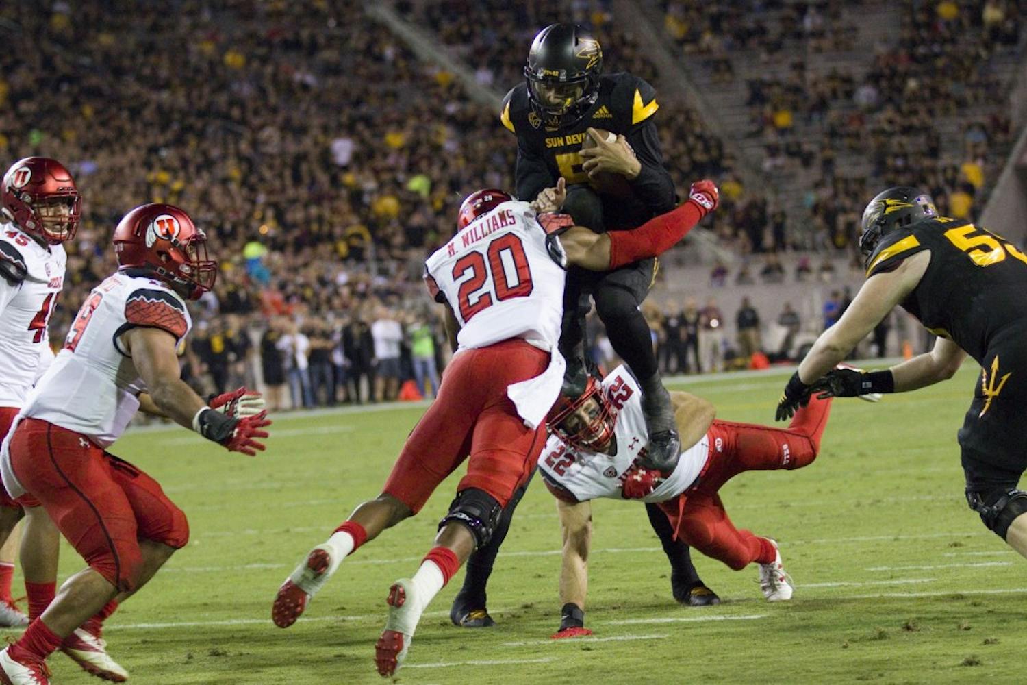 ASU sophomore quarterback Manny Wilkins (5) tries to hurdle a Utah free safety Marcus Williams on the goal line in the first half of a game versus the Utah Utes in Sun Devil Stadium in Tempe, Arizona, on Thursday, Nov. 10, 2016. 