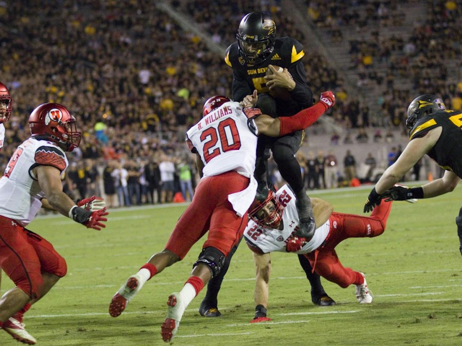 ASU sophomore quarterback Manny Wilkins (5) tries to hurdle a Utah free safety Marcus Williams on the goal line in the first half of a game versus the Utah Utes in Sun Devil Stadium in Tempe, Arizona, on Thursday, Nov. 10, 2016. 