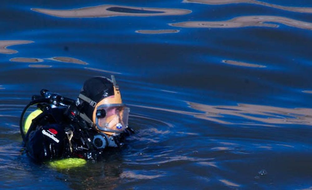 BELOW THE SURFACE: The Tempe Fire Department deployed divers on Thursday to comb the bottom of Tempe Town Lake looking for clues to Willie Jigba’s disappearance. Jigba, 24, has been missing since Jan. 15. (Photo by Lisa Bartoli)