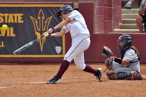 Fully capable: ASU freshman pitcher Dallas Escobedo (right) warms up before pitching against UC Santa Barbara on Saturday. Escobedo came in highly touted and has so far been dominant in the circle this season. (Photo by Michael Arellano)