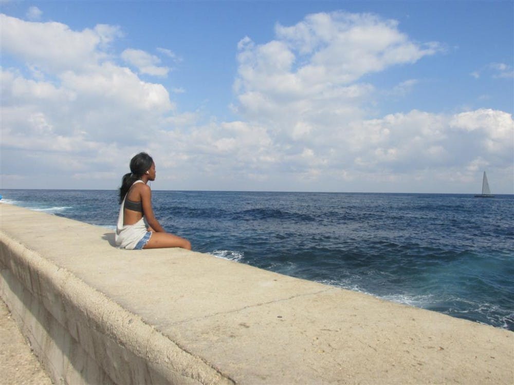 Paula Cullison's photo "Looking to the Future" features a girl sitting&nbsp;on the Malecón&nbsp;on the&nbsp;coast of Havana, Cuba&nbsp;on Feb. 7, 2016. The&nbsp;art exhibit at the Fletcher Library runs through Dec. 3.&nbsp;