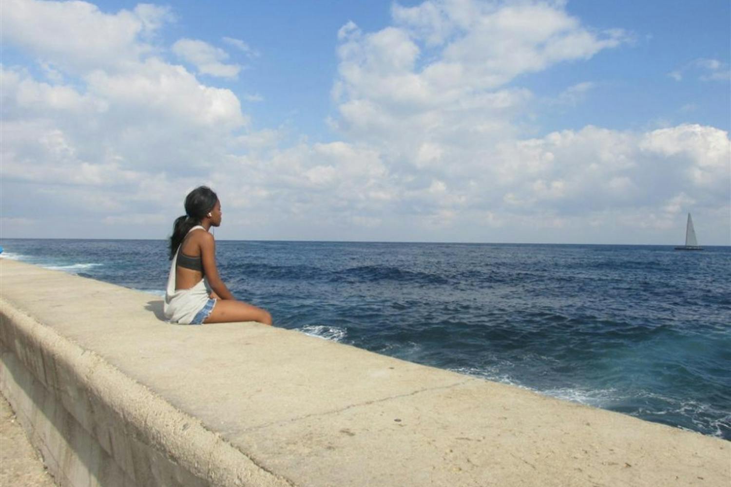 Paula Cullison's photo "Looking to the Future" features a girl sitting&nbsp;on the Malecón&nbsp;on the&nbsp;coast of Havana, Cuba&nbsp;on Feb. 7, 2016. The&nbsp;art exhibit at the Fletcher Library runs through Dec. 3.&nbsp;