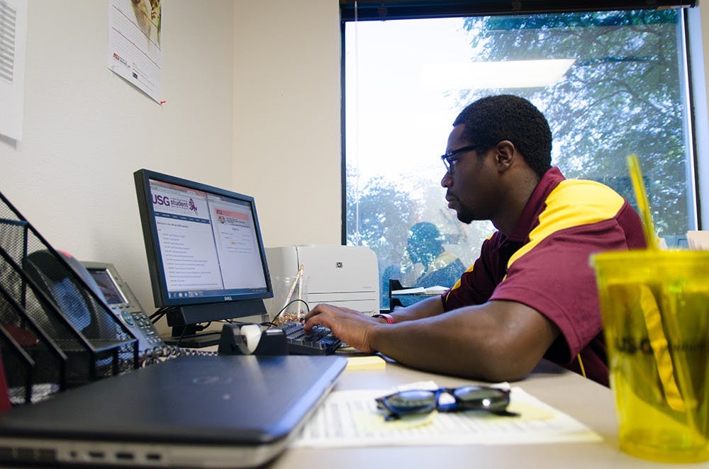 USG Polytechnic President Franz Ferguson poses for a photograph in the doorway of his office several hours before most other students will be on campus. (Photo by Andrew Ybanez)
