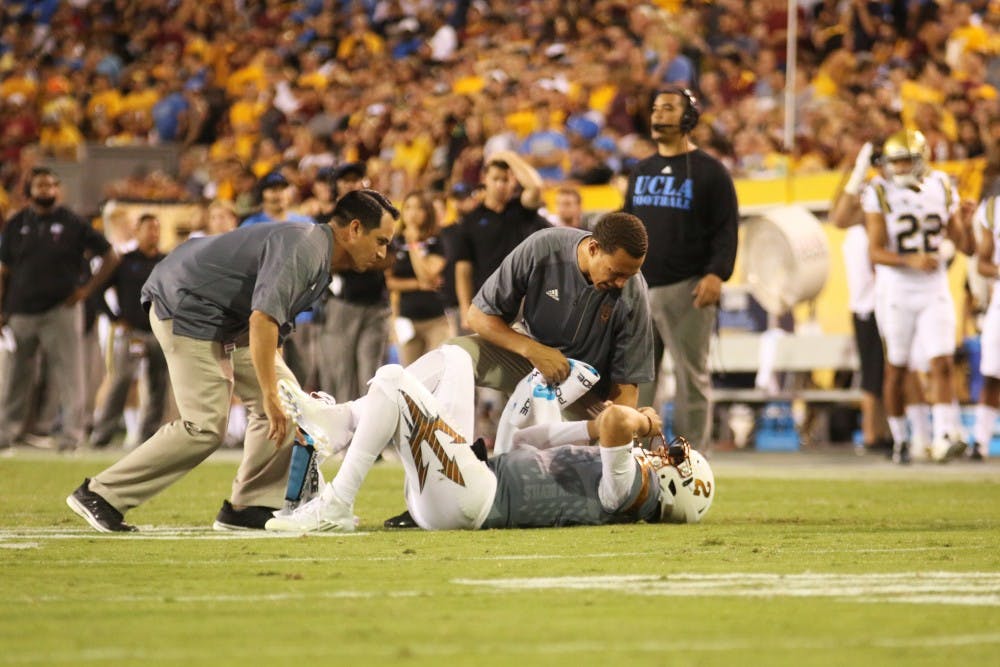 ASU Sun Devils quarterback Brady White (2) lies on the ground after having been hurt during the second half of a game against the UCLA Bruins in Sun Devil Stadium in Tempe, Arizona, on Saturday, Oct. 8, 2016.