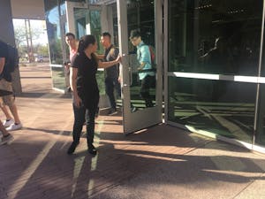 Students perform random acts of kindness on ASU's downtown campus by holding the door open for each other.