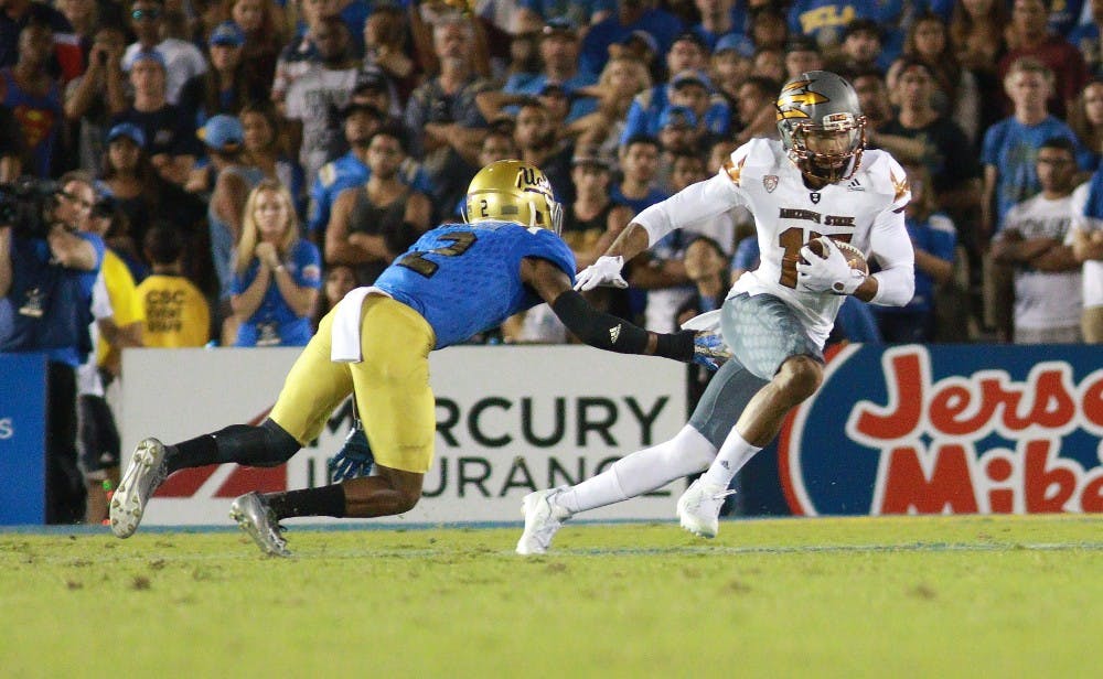 Redshirt senior wide receiver Devin Lucien (15) breaks a tackle after catching a pass in the third quarter against UCLA on Saturday, Oct. 3, 2015, at Rose Bowl in Pasadena, California. The Sun Devils defeated the Bruins 38-23.