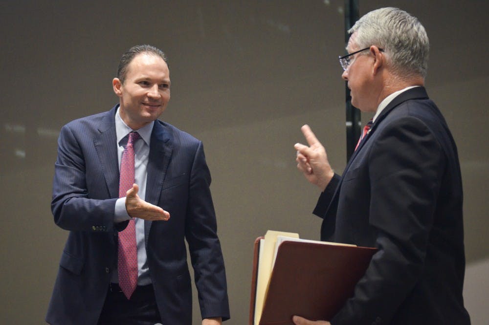 Maricopa County Attorney Bill Montgomery rejects a handshake from J.P. Holyoak, a Marijuana Policy Project campaign chairman, after a debate between them on Sept. 13, 2016.