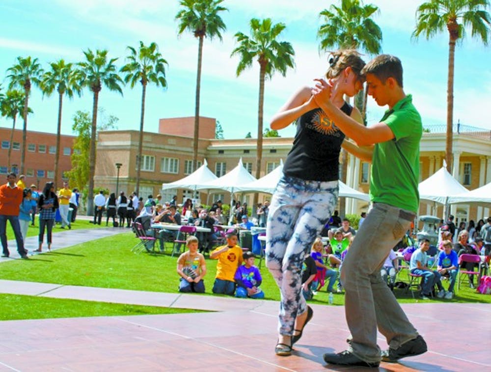 TAKES TWO TO TANGO: Senior biochemistry major Glen Feder and sophomore elementary education major Cassi Willis represent the ASU Argentine Tango Club at the World Festival Tuesday afternoon on Hayden Lawn.  (Photo by Katy Tipton)