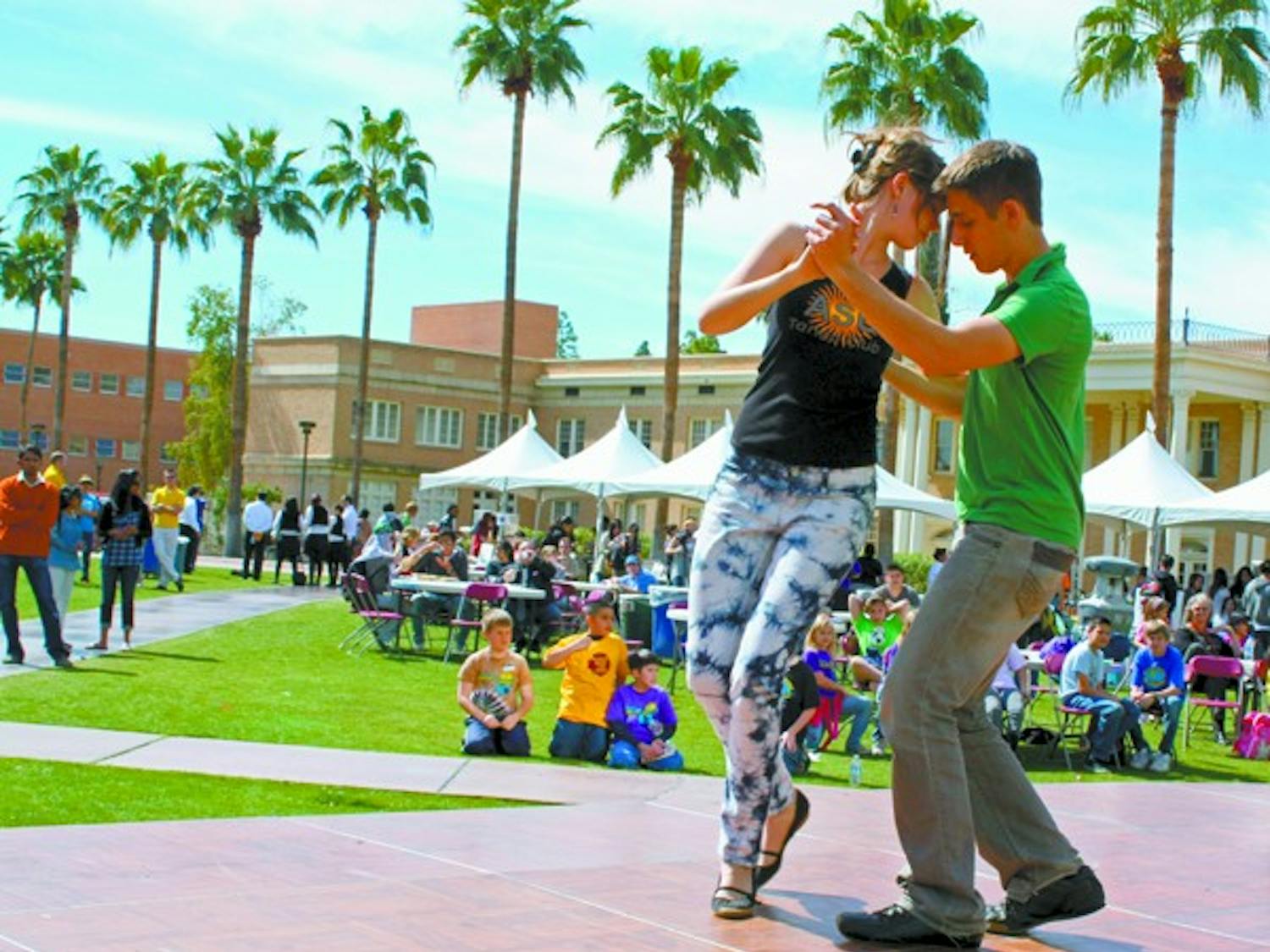 TAKES TWO TO TANGO: Senior biochemistry major Glen Feder and sophomore elementary education major Cassi Willis represent the ASU Argentine Tango Club at the World Festival Tuesday afternoon on Hayden Lawn.  (Photo by Katy Tipton)