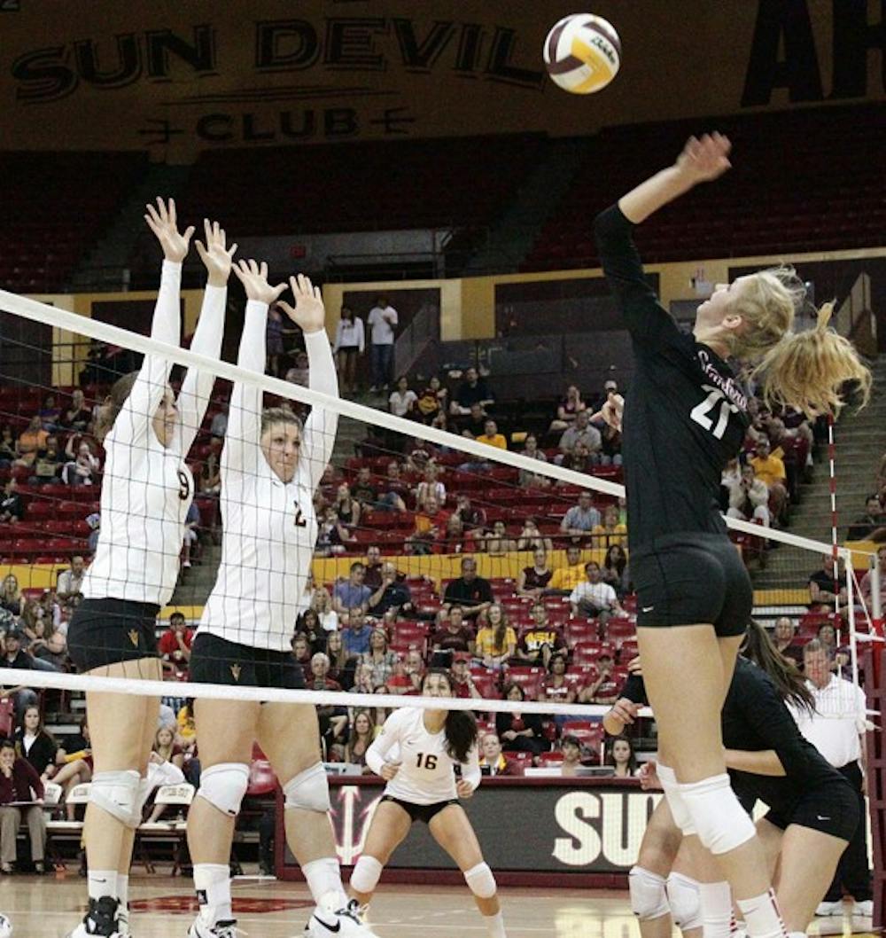 STAYING STRONG: Redshirt freshman hitter Kylee Terhune (9) and senior middle blocker Sonja Markanovich (2) extend to block Stanford junior outside hitter Hayley Spelman (21) during the Cardinal’s 3-1 win over the Sun Devils. The Sun Devils hope to even up their series against Washington and Washington State over the weekend. (Photo by Beth Easterbrook)