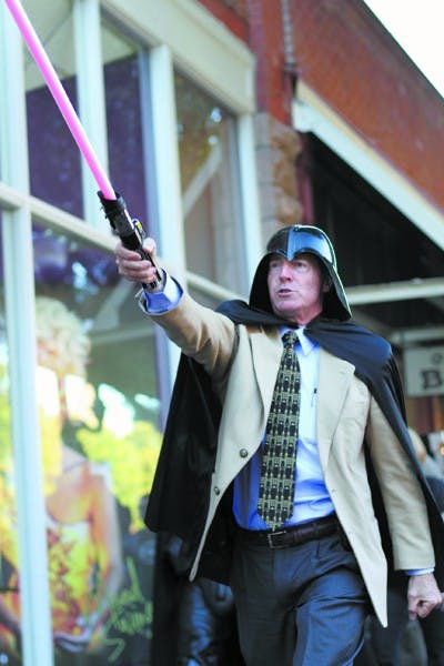 Dressed as Darth Vader, Tempe Mayor Hugh Hallman leads a pack of Star Wars fanatics down Mill Avenue late Friday afternoon to film a promotional video for the upcoming Geeks Night Out. (Photo by Sam Rosenbaum)