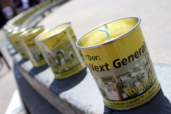 Candles line the stage in front of the Memorial Union on the Tempe campus Thursday to remember the millions of lives lost during the Holocaust. (Photo by Jessie Wardarski)