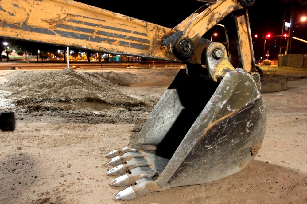 A view of a bulldozer near Apache Drive. The now empty lot which houses nothing but construction equipment was once the mecca of fraternity activity in Tempe. (Photo by Dominic Valente)