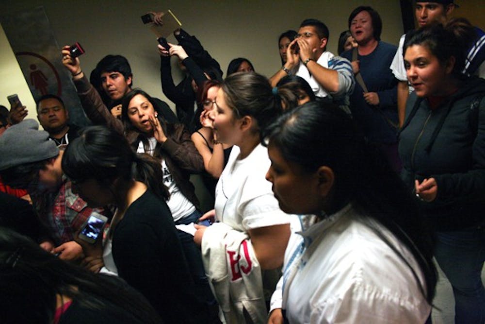 Students protest outside of a classroom where it appears that the College Republicans relocated their meeting in which Sheriff Joe Arpaio. The Thursday night meeting was cancelled, but appeared to have been relocated as a private event in another room. (Photo by Perla Farias)