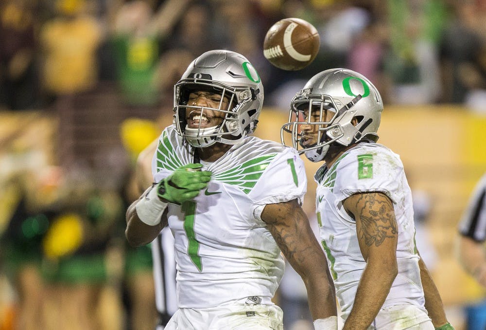 Oregon corner back Arrion Springs, left, celebrates with safety Charles Nelson, right, after pulling in an interception to end a game against ASU on Thursday, Oct. 29, 2015, at Sun Devil Stadium in Tempe, Ariz. The Ducks beat the Sun Devils 61-55 in the third overtime period. 