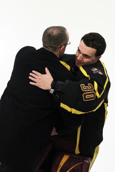 Mark Schacker embraces coach Greg Powers prior to a game against UA on Jan. 28. Schacker’s goaltending was key in the Sun Devils’ 10–3 victory over the Wildcats. (Photo by Lisa Bartoli)