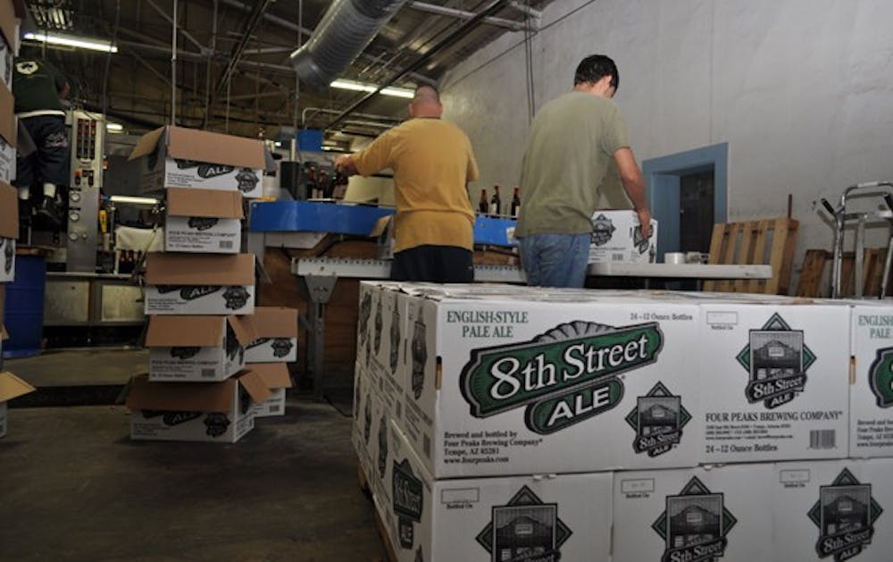 Workers pack up boxes of Ale at Four Peaks Brewery in Tempe. Photo by Alex Forestier.