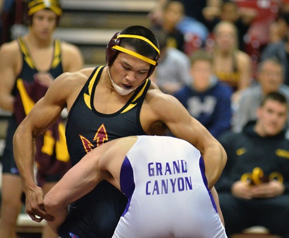STARTING STRONG: ASU senior Eric Starks grapples with Grand Canyon sophomore Justin Martin during the Sun Devils’ 27-16 win over the ‘Lopes on Sunday. ASU swept their first two dual meets of the season after taking down Embry-Riddle the same day. (Photo by Aaron Lavinsky)