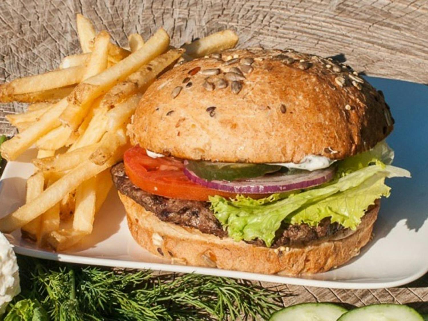 A hamburger and fries are pictured from Joe's Farm Grill.