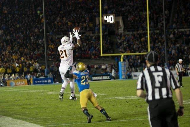 Redshirt sophomore wide reciever Jaelen Strong leaps into the air as he attempts to catch a pass from Taylor Kelly. ASU defeated the Bruins 38-35 and clinched a spot in the Pac-12 championship. (Photo by Dominic Valente.)