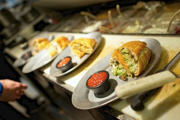 BAKED TO A CRISP: Stuffed pastries sit out to cool before being served at the Cornish Pasty Co on Sunday night. (Photo by Michael Arellano)