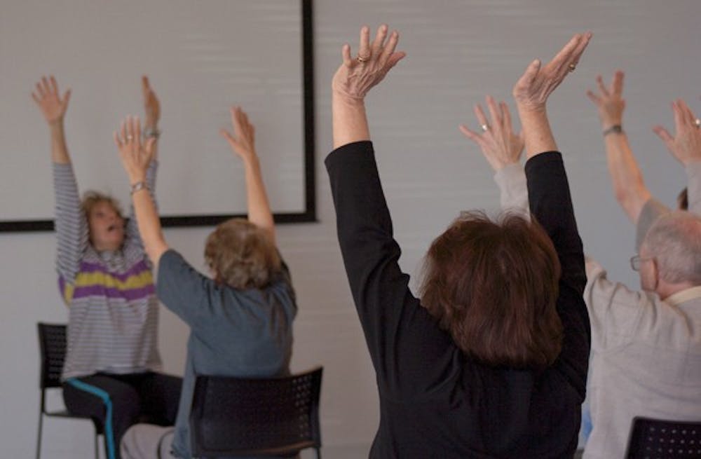 MOVE IT: ASU School of Dance instructor Claudia Murphey leads a class of seniors suffering from Parkinson's disease in a motion and movement class on Wednesday morning at the ASU SkySong Center.  (Photo by Lisa Bartoli)
