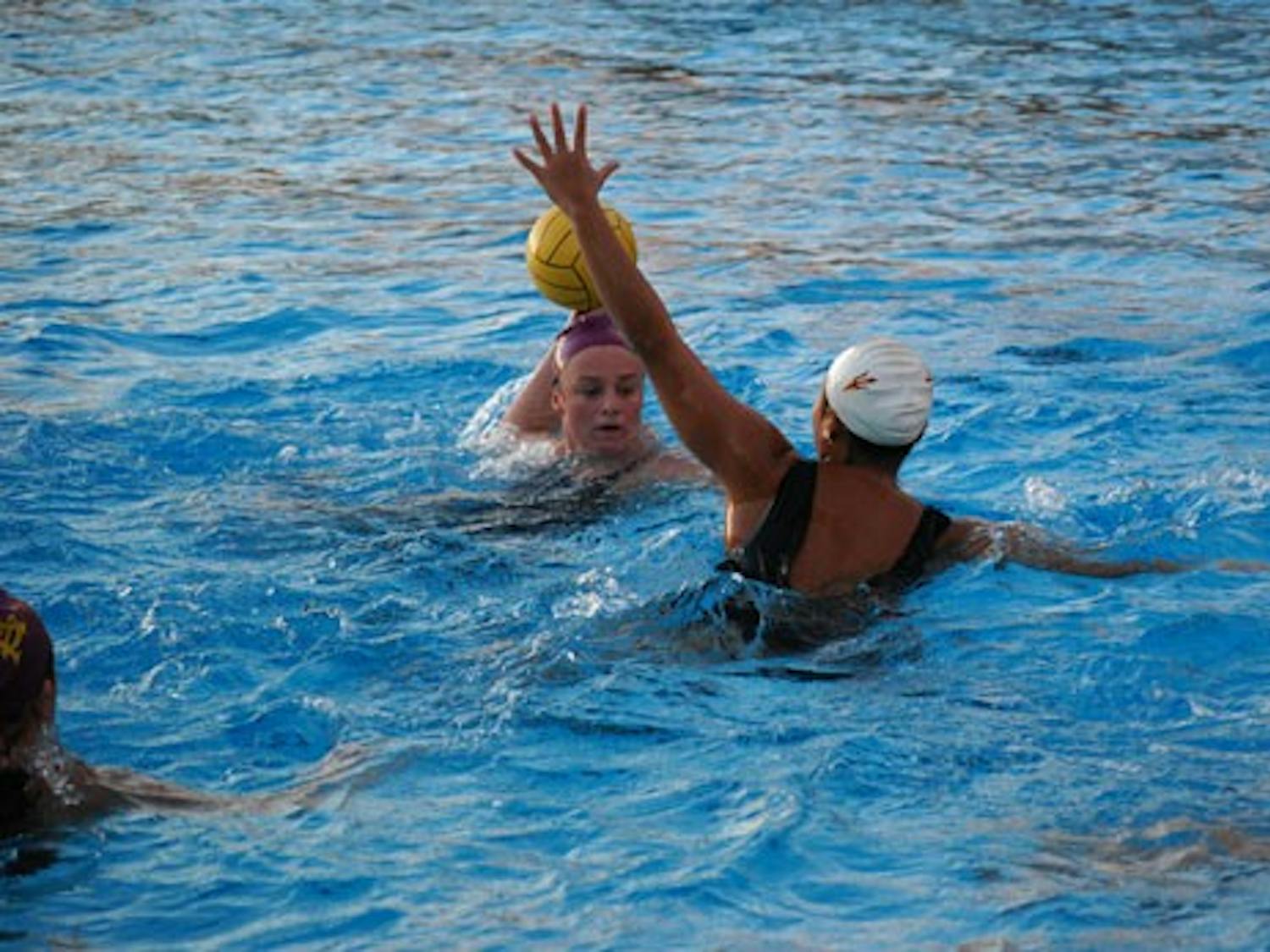 Freshman utility player Katie Sverchek winds her arm back ready to throw during an ASU water polo practice on Jan. 15. The team started off the season the right note going 6-0 in the UCSB tournament. (Photo by Murphy Bannerman)